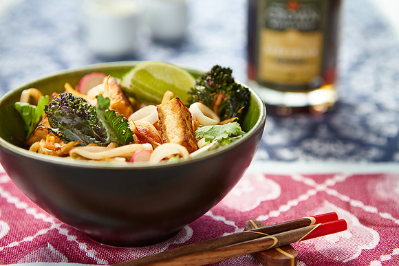 bowl of salad with maple syrup on the background